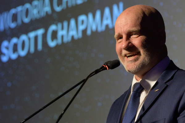 RFDS Victoria Chief Executive, Scott Chapman speaks before a podium at the Going The Distance Gala Dinner.