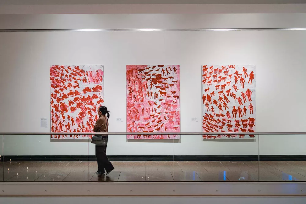 A person views a work of art in an exhibition