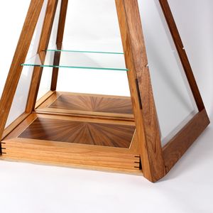 A close up detail of the document box in a handmade pyramid design wooden and glass cabinet