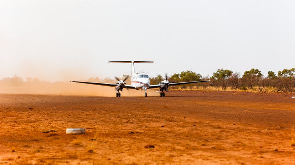 RFDS (Queensland Section) aircraft landing on dirt runway