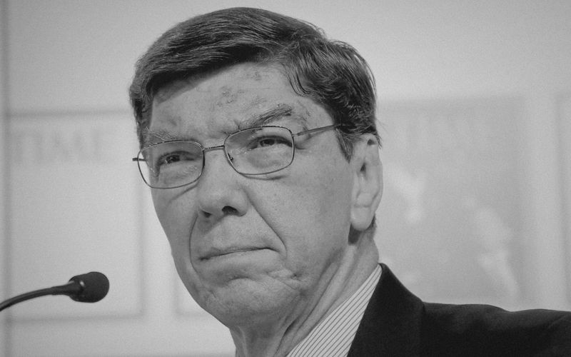 Black & white portrait photo of Clay Christensen in a suite and tie