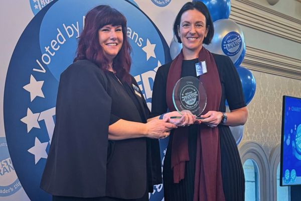 Chief Exec RFDS Emma Buchanan receiving award from Cathy Johnson from Readers Digest
