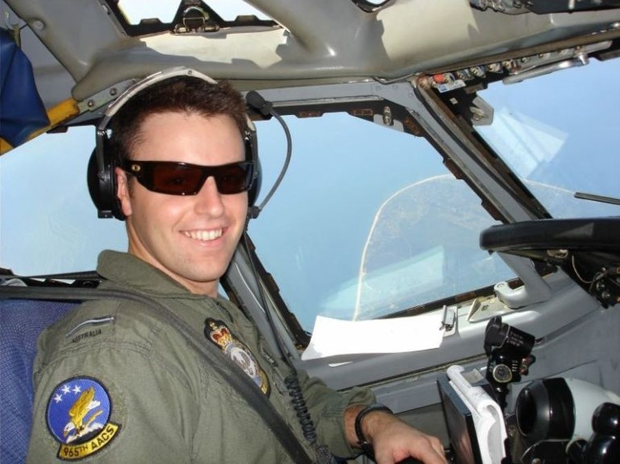 Jason smiling while flying a plane