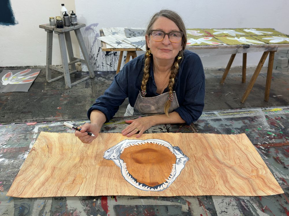 A photo of Helen Britton in her studio working on an artwork