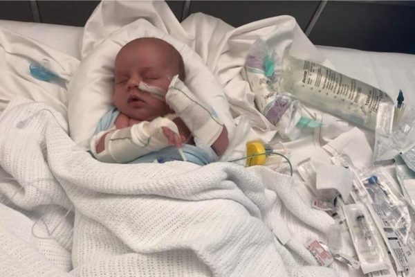 Baby Jack is in a hospital bed with medical equipment