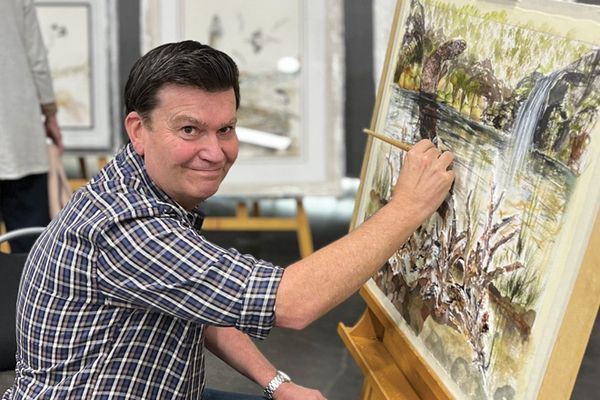 Stuart painting a donated painting