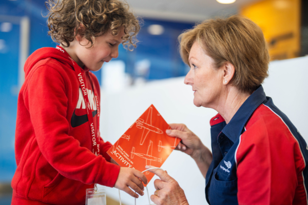 RFDS team member giving an activity book to a young boy