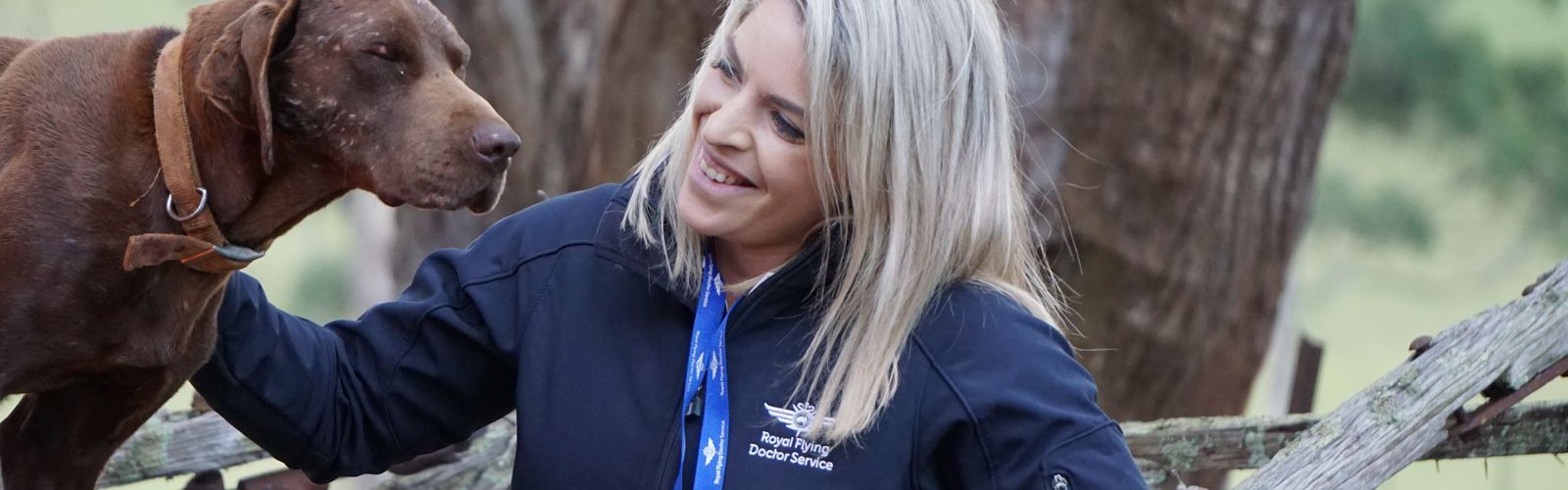 Harriet from RFDS Tasmania with a dog.