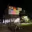 photo of collage projected on wall in forecourt after dark