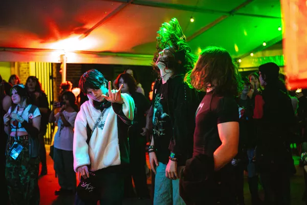 Young people dancing in group.