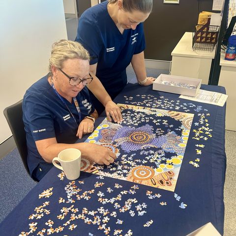 Staff doing the puzzle at Base 