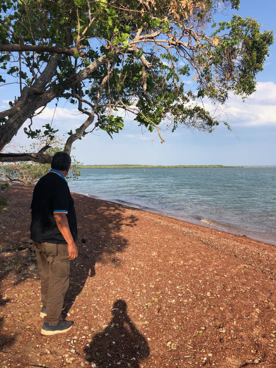 Person stands on isolated beach