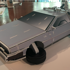 photo of a scaled down DeLorean model made from signage waste material