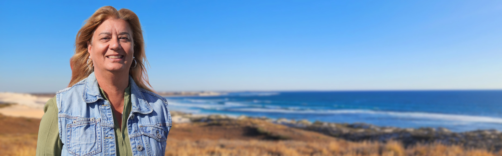 Carol smiling at the beach.