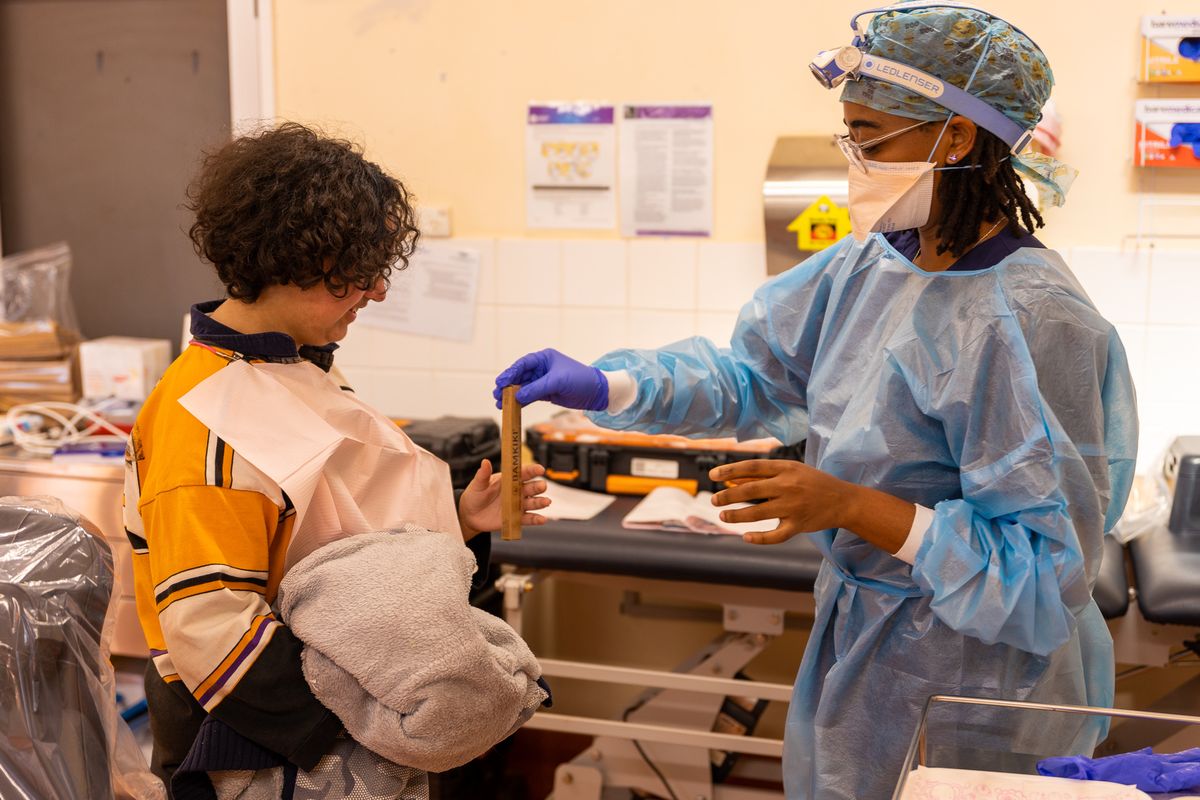 RFDS patient Temiah Randall-Cross receives a toothbrush from Dental Hygienist Marcelyne Patsanza