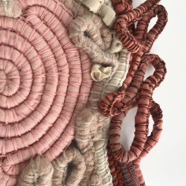 A close up detail of coiled and woven vintage blankets that form the crusty clay pans of Kati Thanda