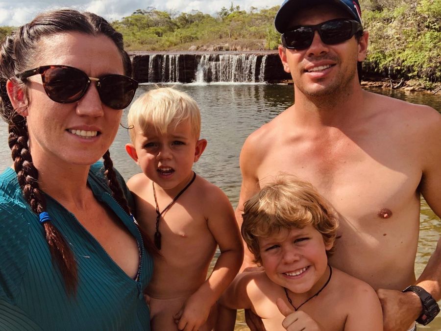 The four family members are standing together and smiling.