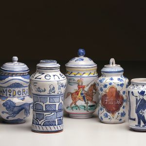 6 ceramic apothecary pots touting covid-19 cures