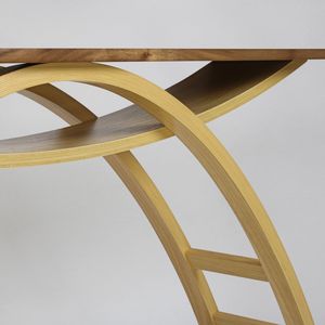 A finely detailed close-up of a wooden hall table with light, arched legs and a darker table-top against a plain, white back-drop.