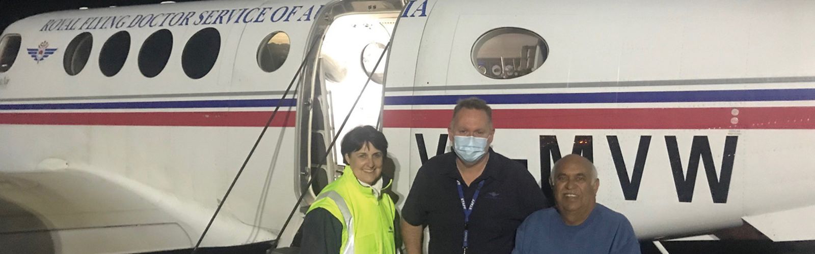 Patient Mervyn Bishop with RFDS Doctors in front plane