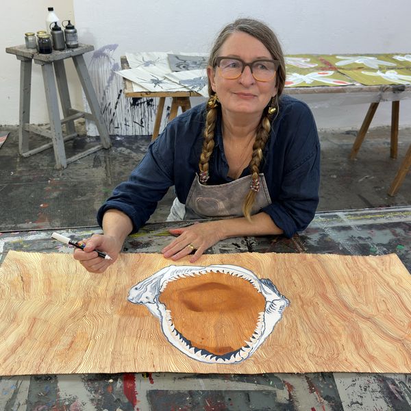 A photo of Helen Britton in her studio working on an artwork