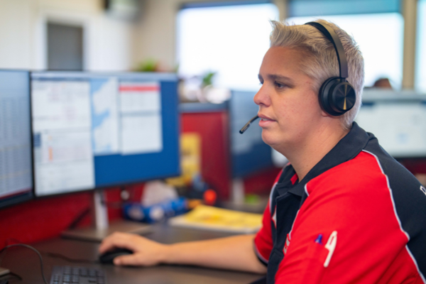 Operations Coordinator answering the phone on her headset.