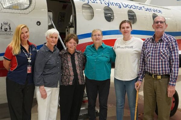 Ancestors smiling in front of a PC-12.