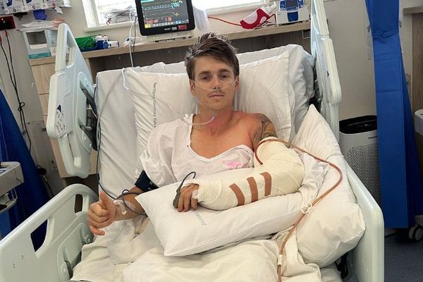 Callum smiling in a hospital bed