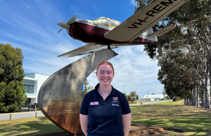 Tessa standing in front of the Robin Miller inspired statue out the front of the RFDS.