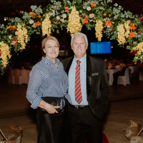 couple under flower arch 