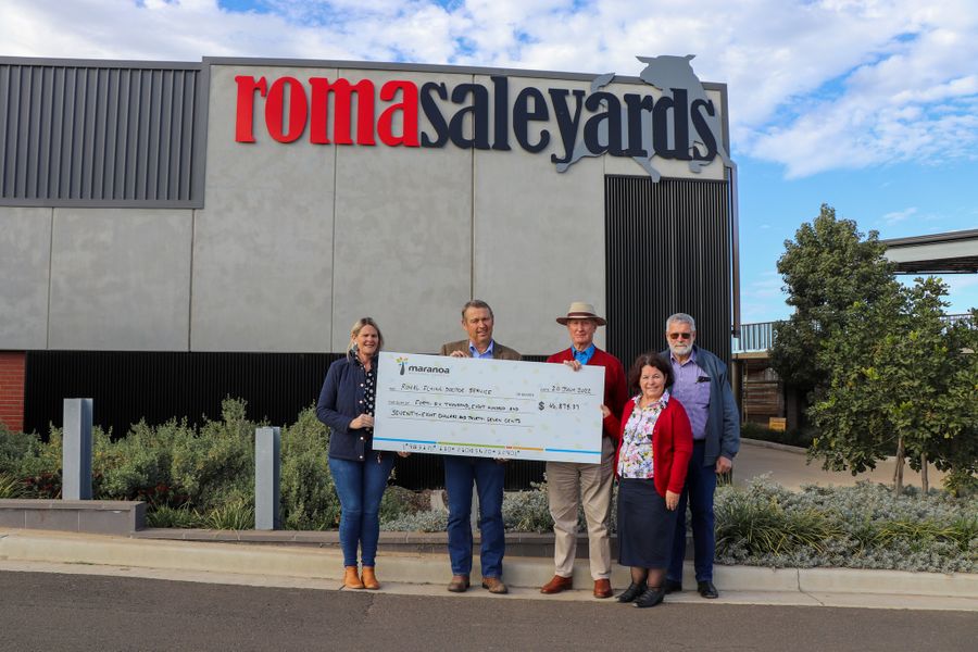 Four people are standing next to each other and holding a large check for $46,878.37.