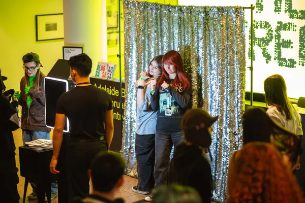 Young people have image taken of them in a photobooth