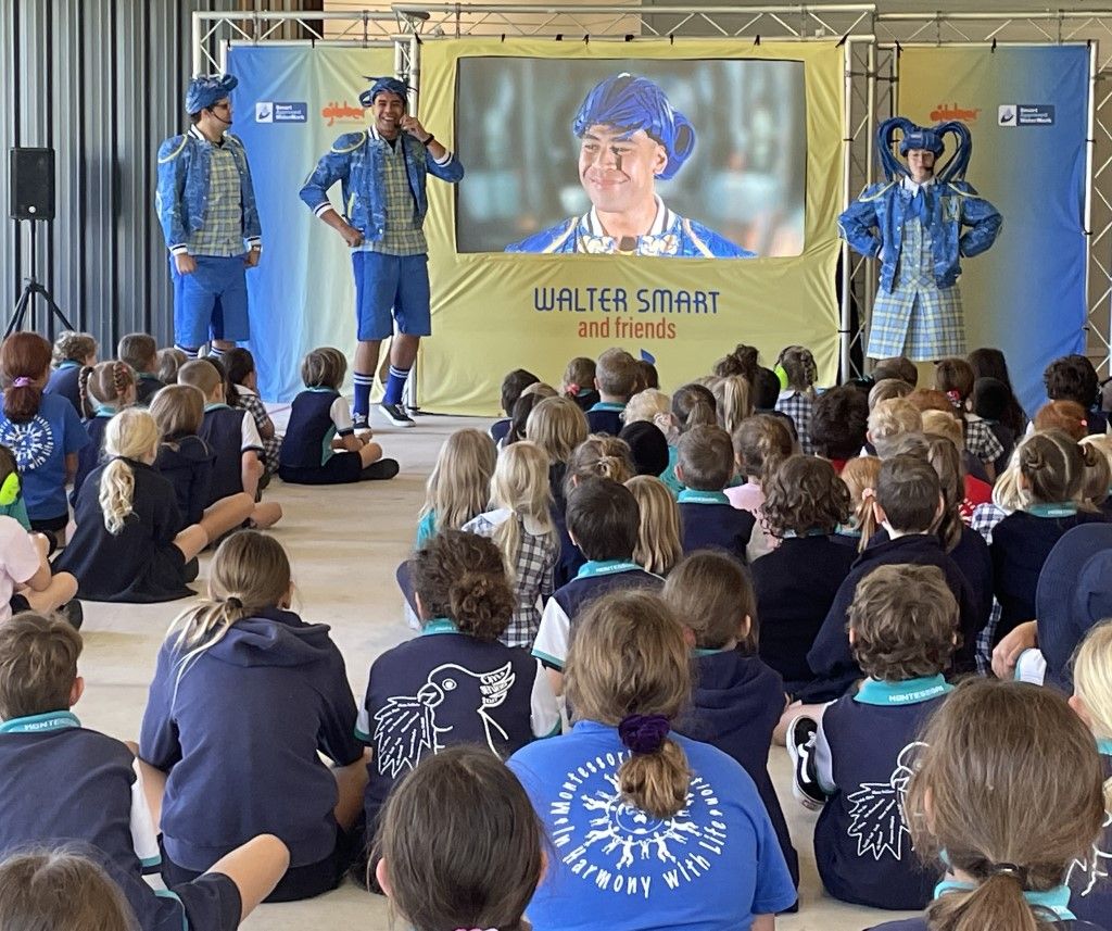 Pantomime performers in front of a class of primary school children