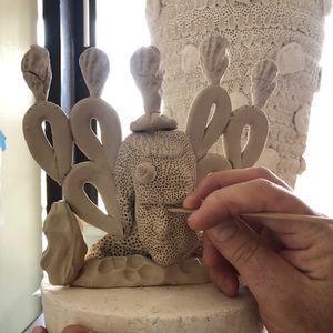 Adding detail to a clay form using a  timber skewer