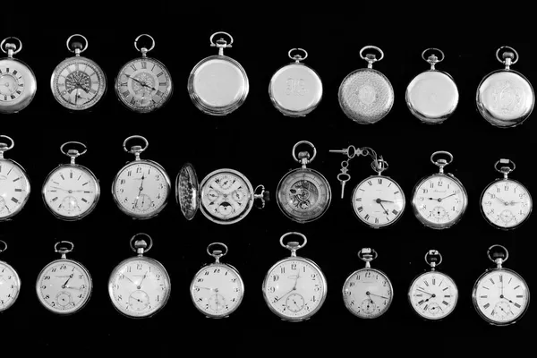 Various vintage pocket watches laid out on a table