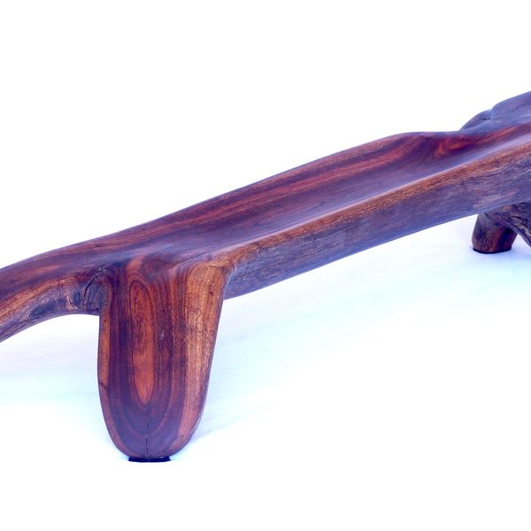 A long low wooden piece with rounded edges on a white background