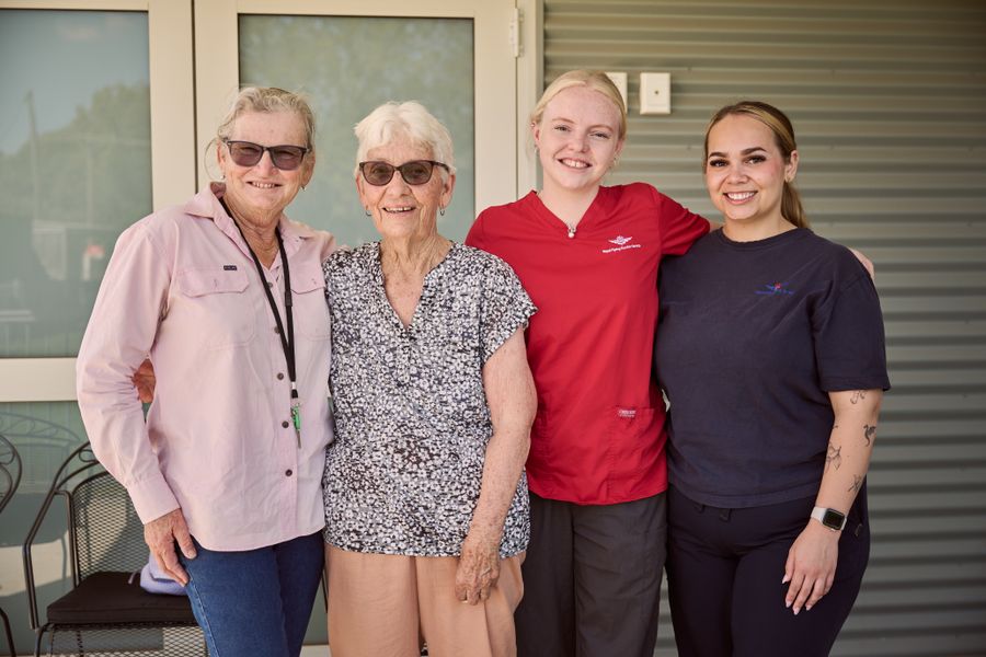 Clinic Coordinator Sharon Junk outside of Louth clinic with community member and dental team