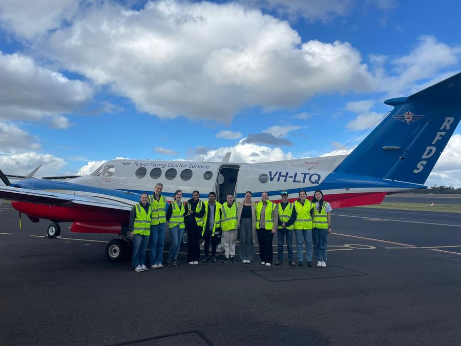 Students in front of RFDS plane 