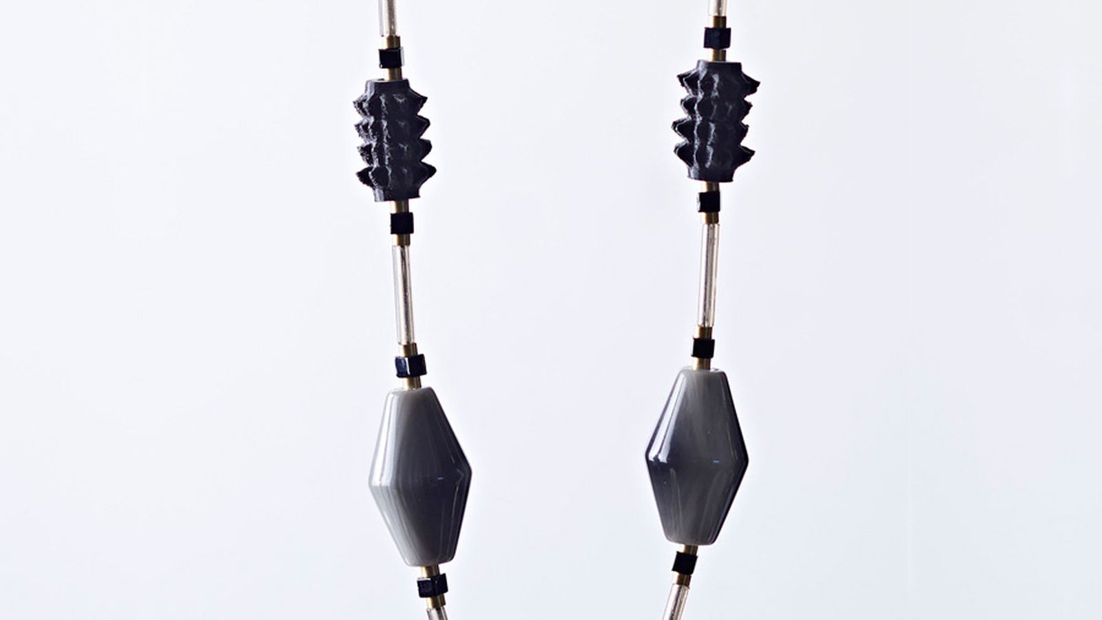 Necklace with chunky black and grey beads and fine chain.