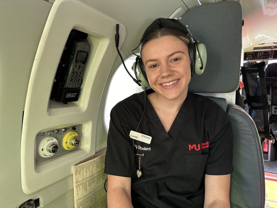 Camille smiling in the PC-12 with a headset on.