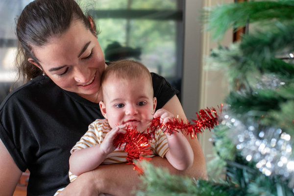 Helen and baby Theo at the Christmas tree