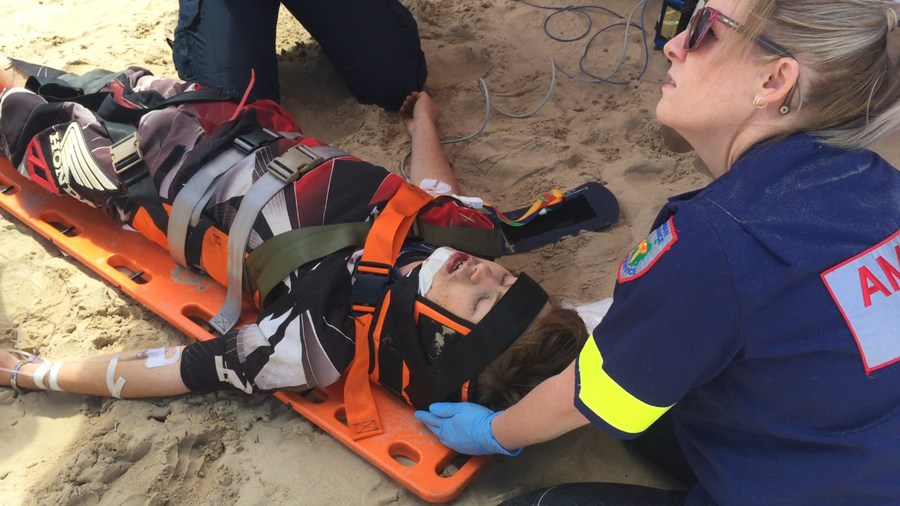 Samuel being stabilised on the beach