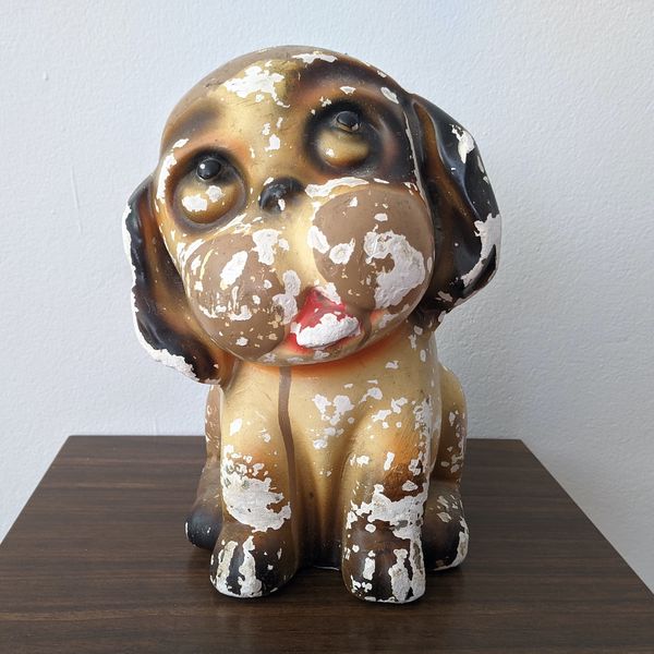 A plaster dog with chipped paint