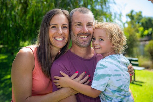 Parker smiling with his Mum and Dad