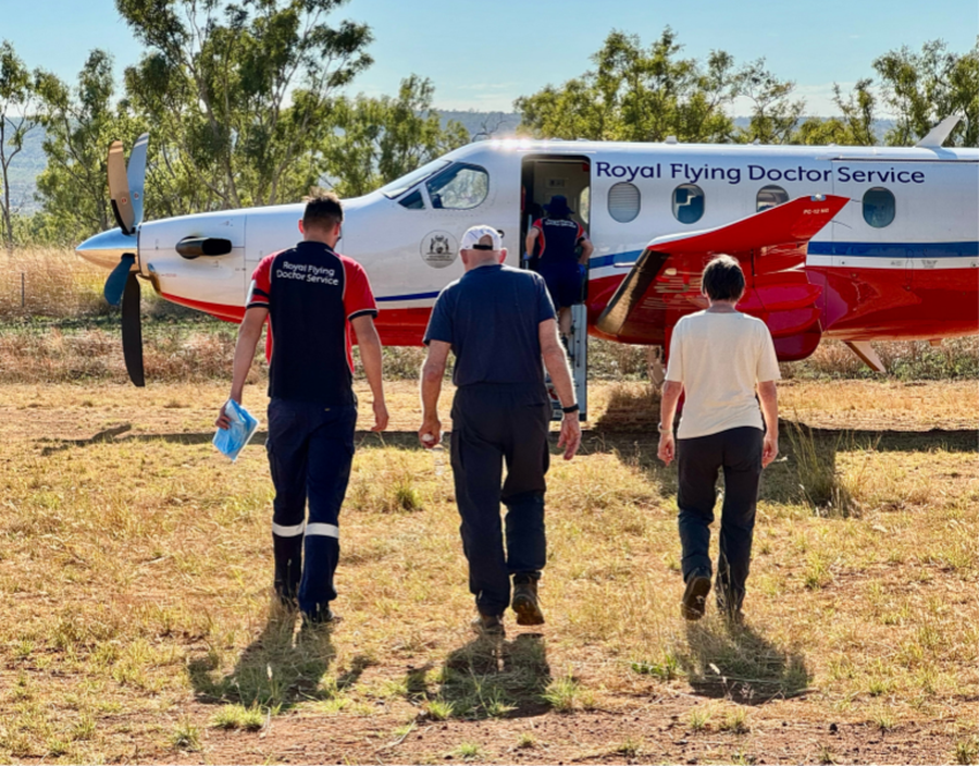 RFDS crew and patient walking towards PC-12.