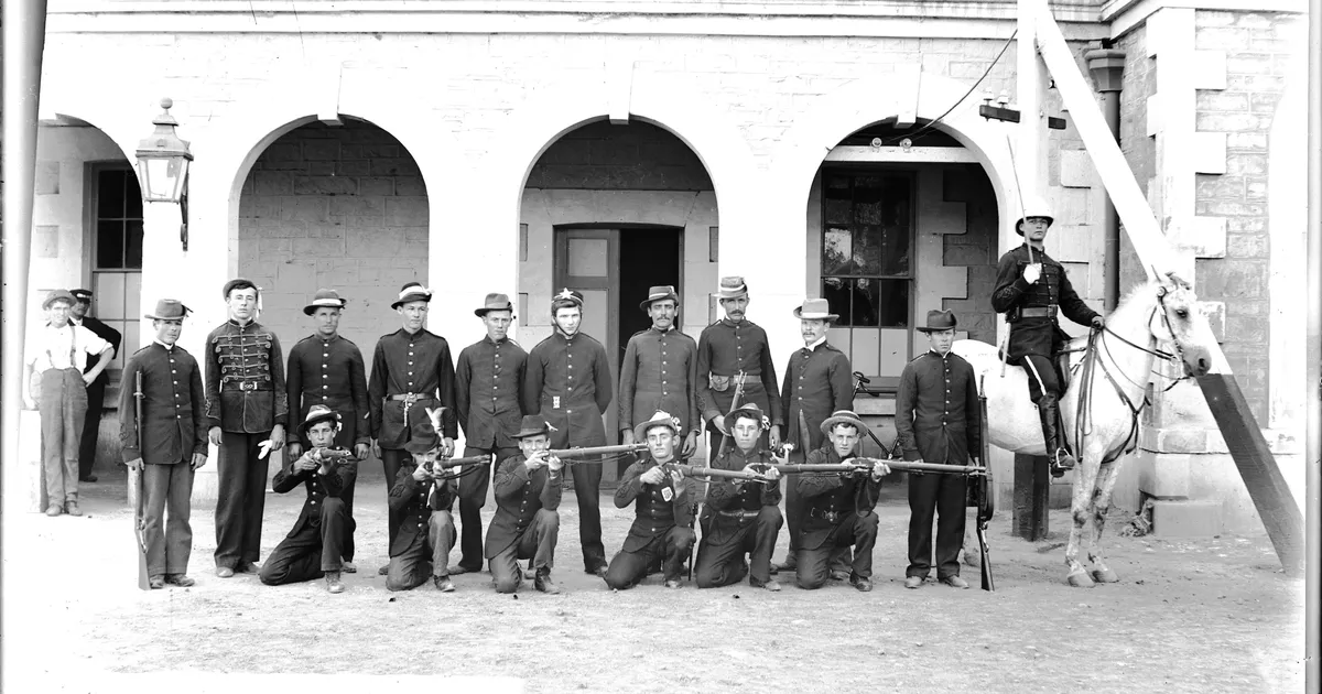 Group of riflemen, house at right - AGSA Collection