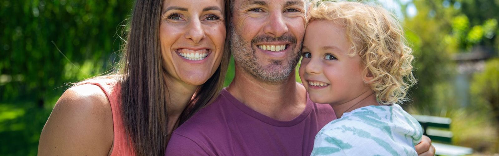 Parker smiling with his Mum and Dad
