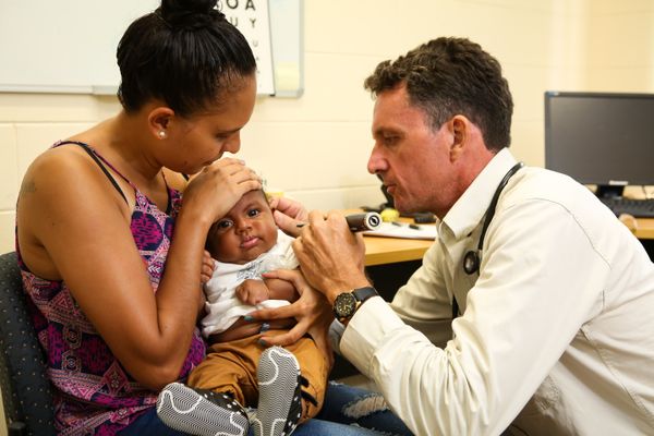 Clinician checking a child