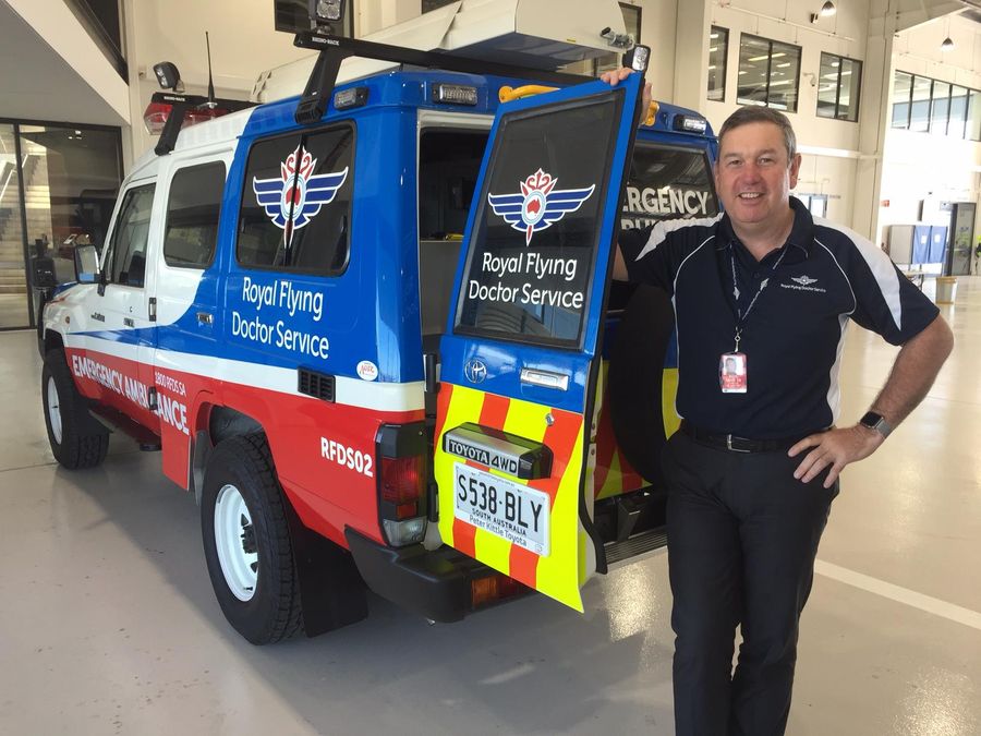 A RFDS Road ambulance. A man smiles 