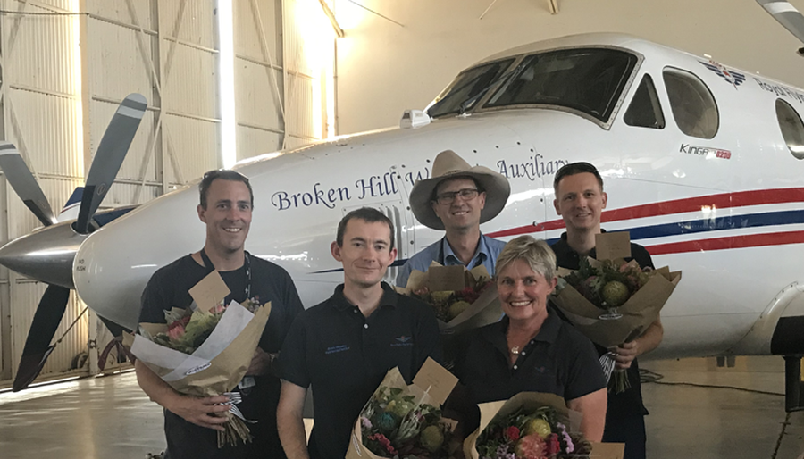 Staff in front of plane